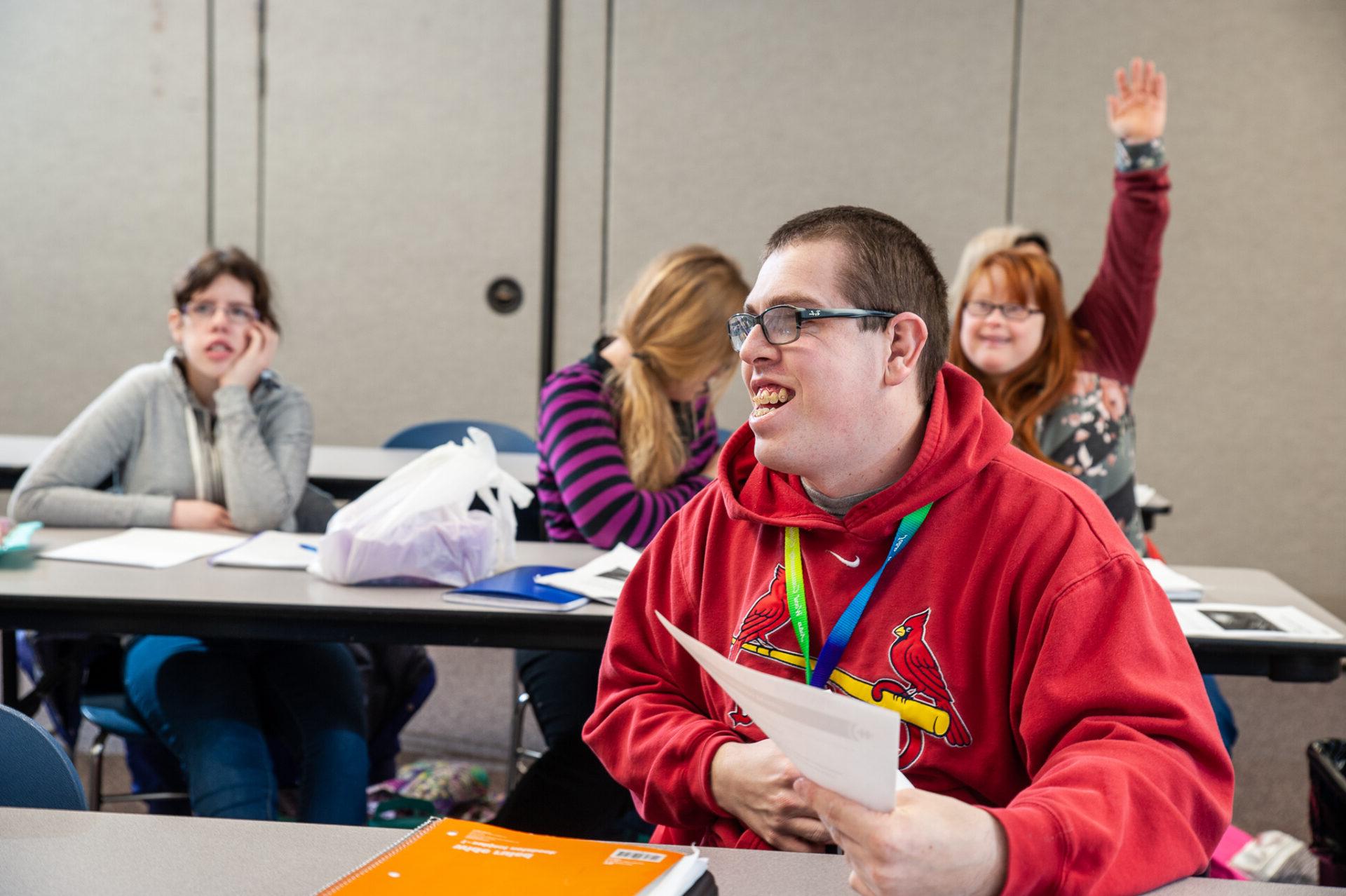 College for life students raise their hand to answer the professor's question